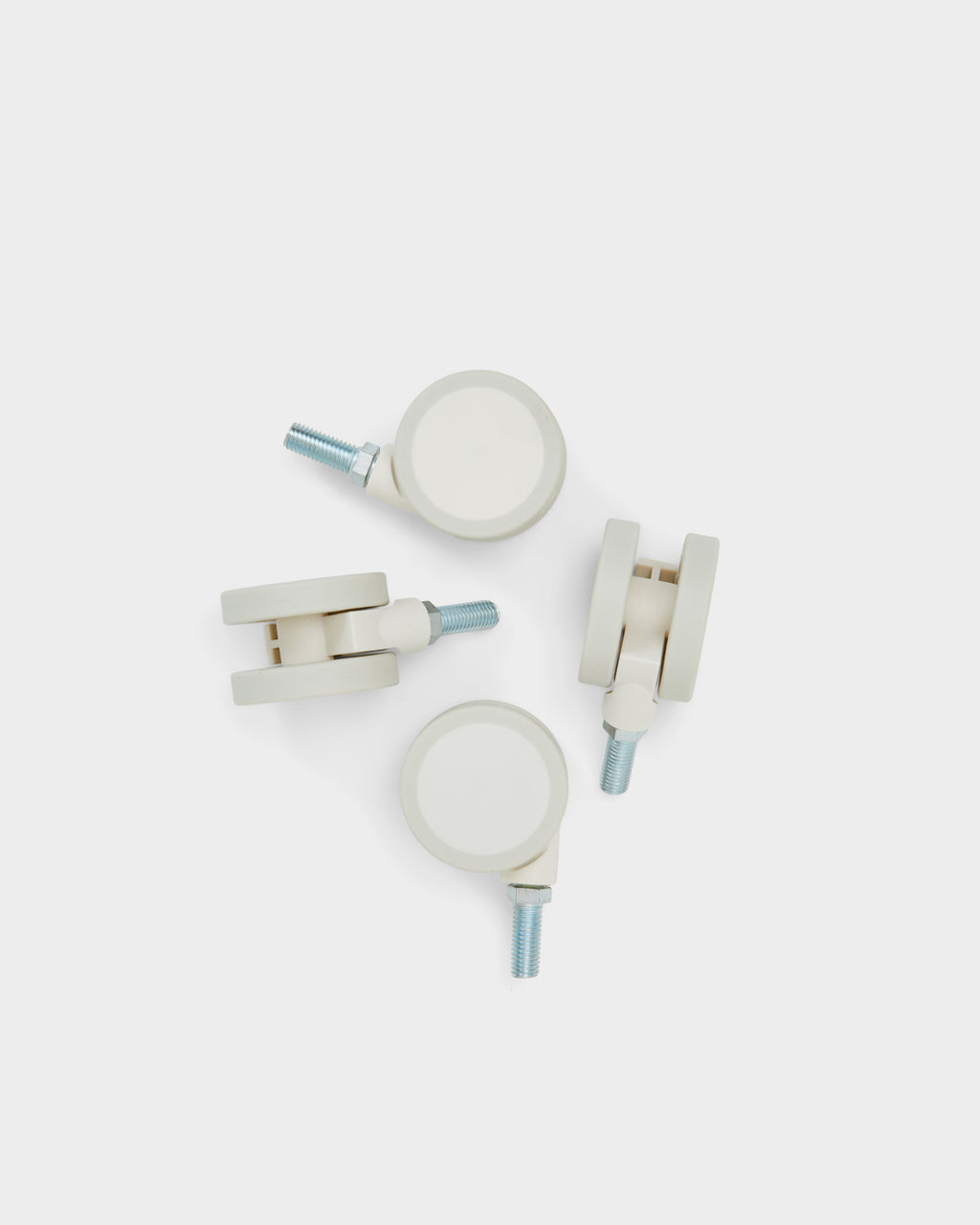 Set of four Wheels in Pearl casters with threaded steel stems, arranged on a light studio backdrop