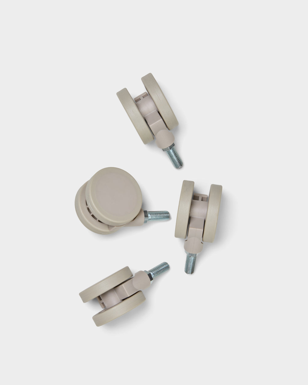 Set of four Wheels in Oat casters with threaded metal stems, studio packshot arranged on a light grey background
