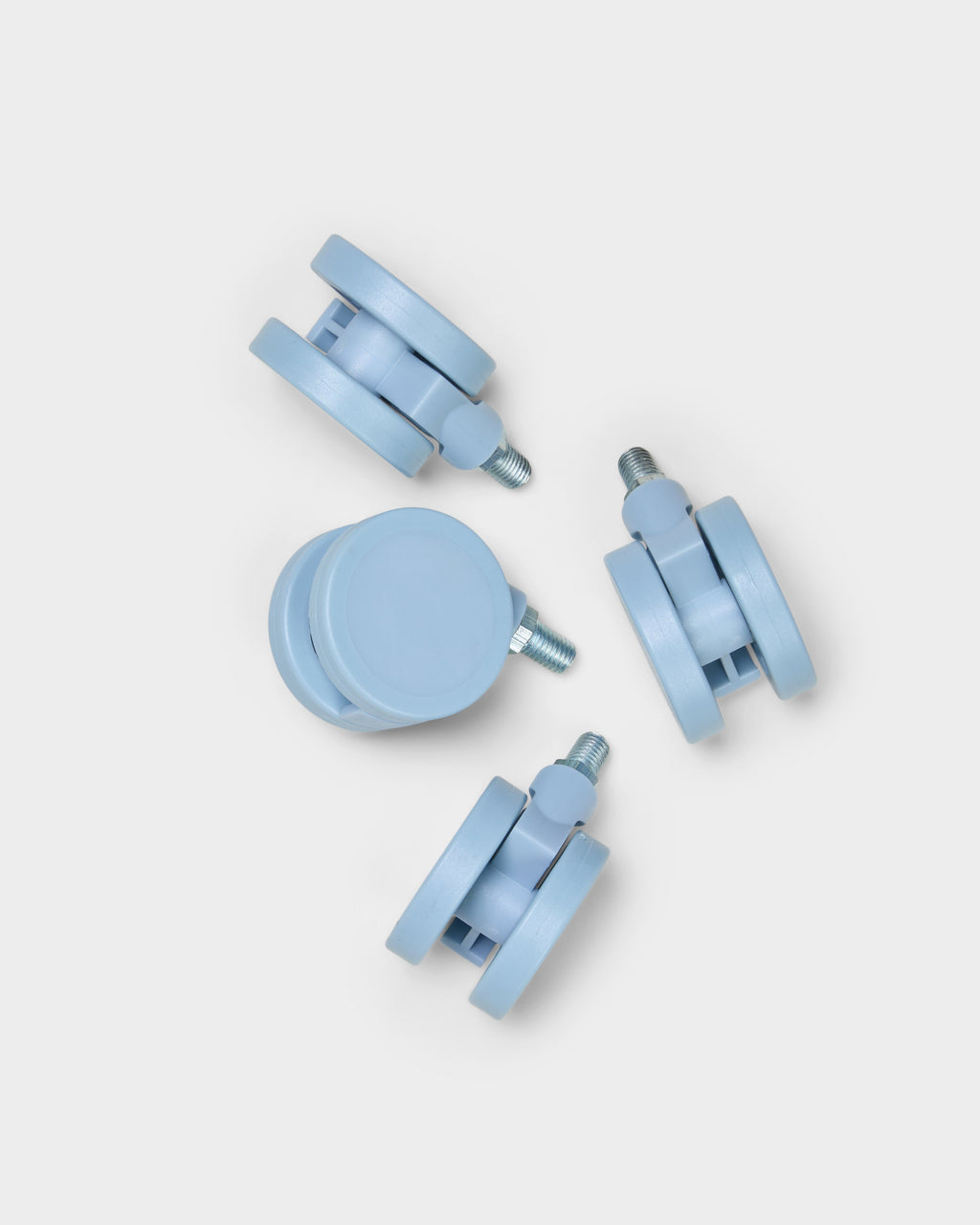 Set of four powder blue caster wheels with metal threaded stems, arranged on a light studio backdrop
