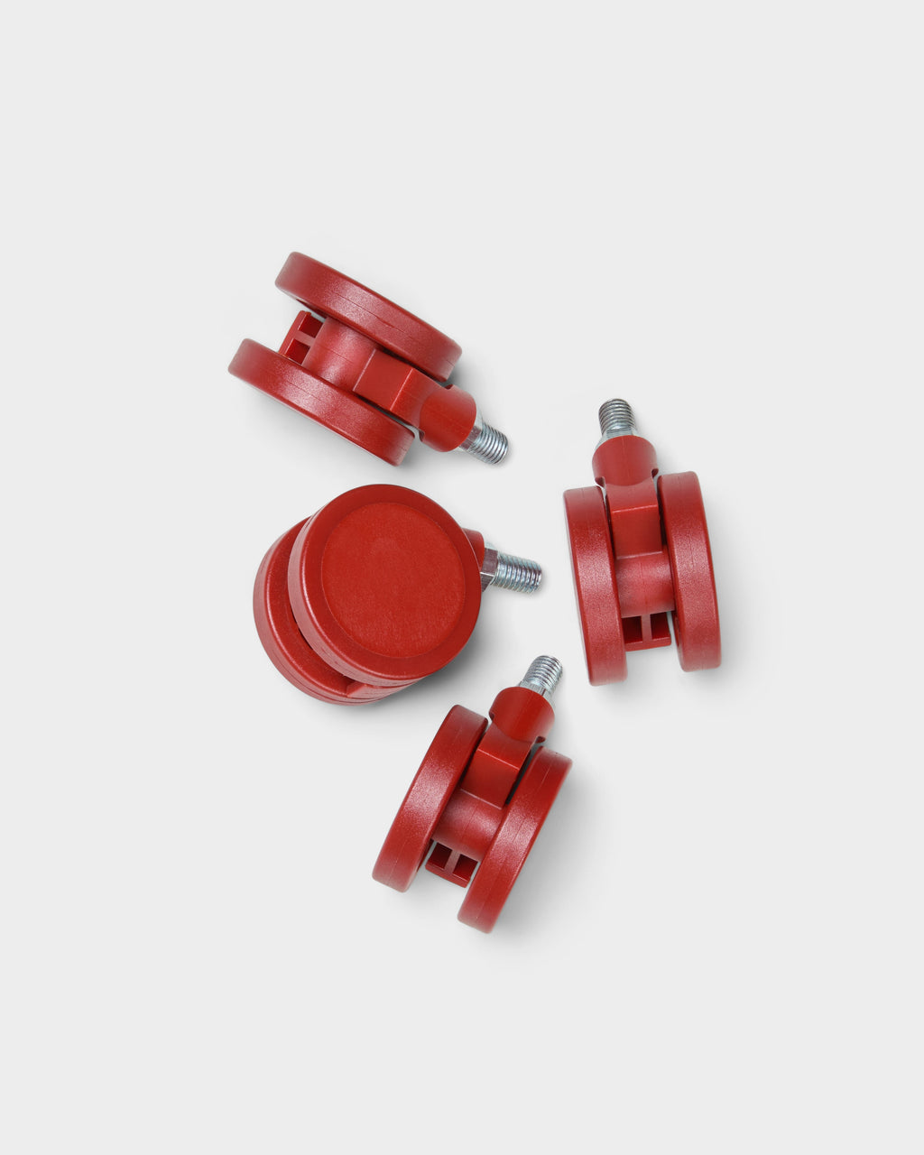 Set of four Wheels in Burnin' Red casters with threaded metal stems, studio packshot from above on light grey