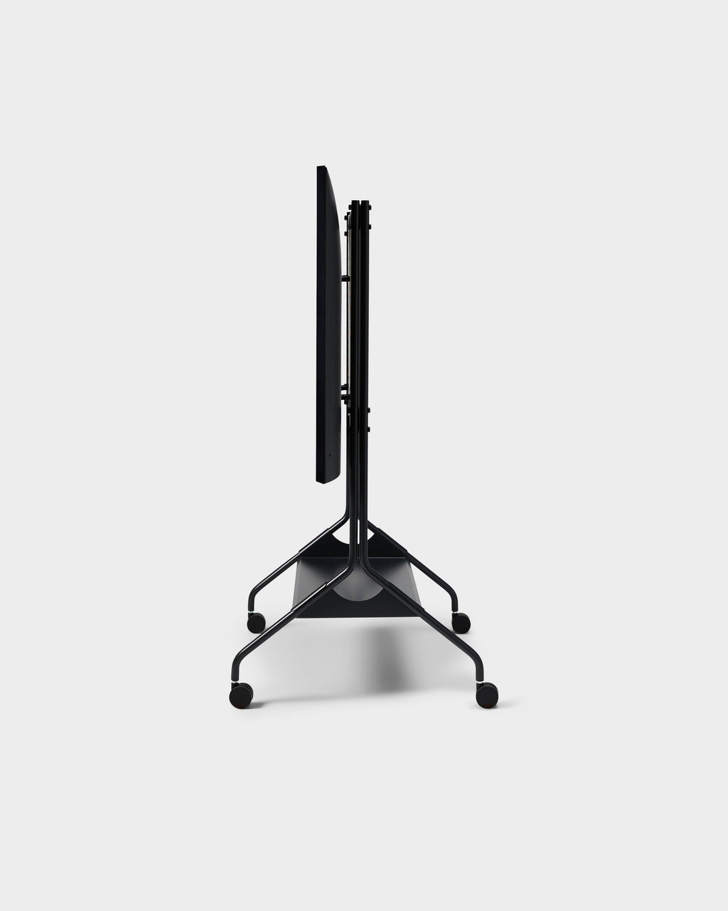 Side profile studio shot of the Moon Tray Shelf in Charcoal, folded flat on its rolling caster base