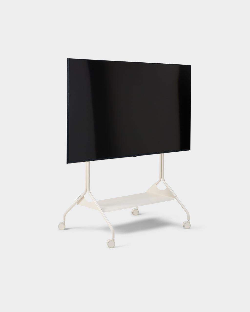Moon Tray Shelf in Pearl mounted on a rolling TV stand with flat screen, angled studio view on white background