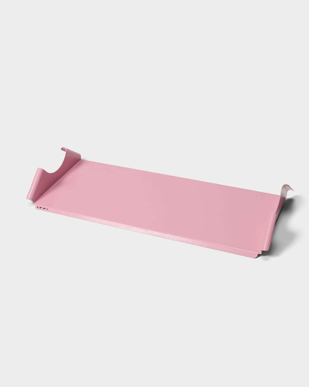 Moon Tray Shelf in Bubble Gum pink shown at an angle in a studio packshot, curved wall brackets and flat tray visible