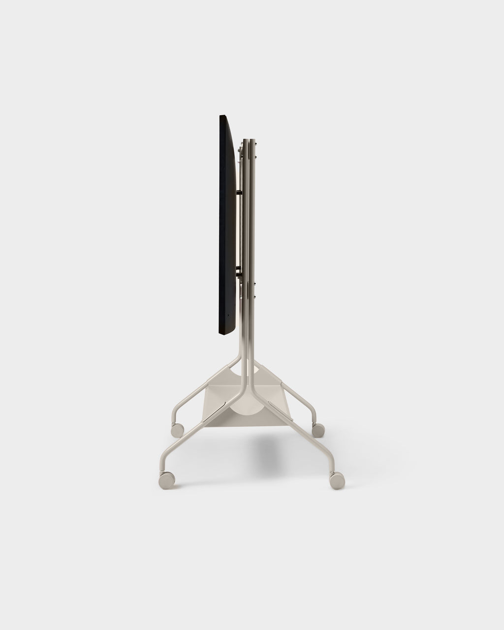 Side profile of oat Moon Tray Shelf on a rolling TV stand with casters, mounted display edge-on, studio packshot