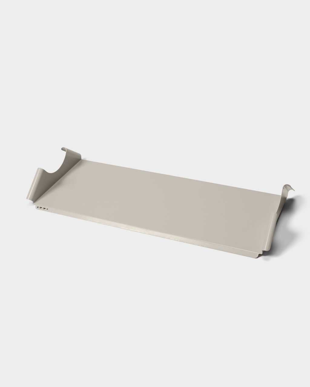 Moon Tray Shelf in Oat shown at an angle in a studio packshot, highlighting its curved metal hooks and flat tray