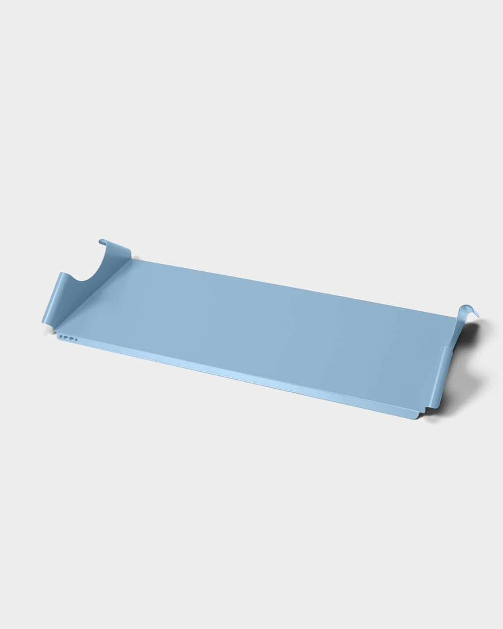 Moon Tray Shelf in powder blue shown at an angle in a studio packshot, revealing upturned hooked edges and vent holes