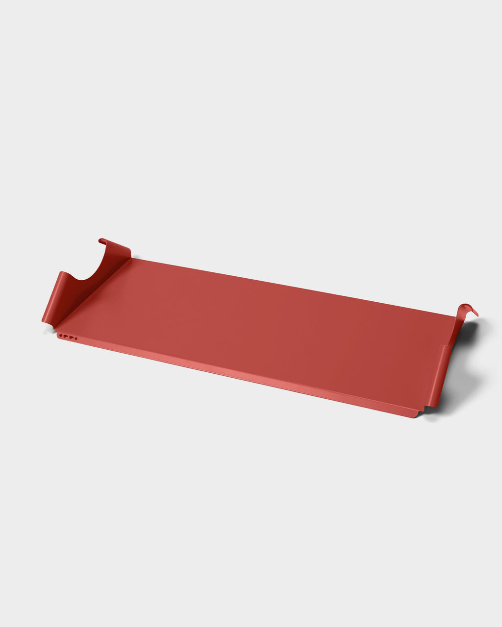 Moon Tray Shelf in Burnin' Red shown at an angle in a studio packshot, highlighting its curved wall-mount hooks