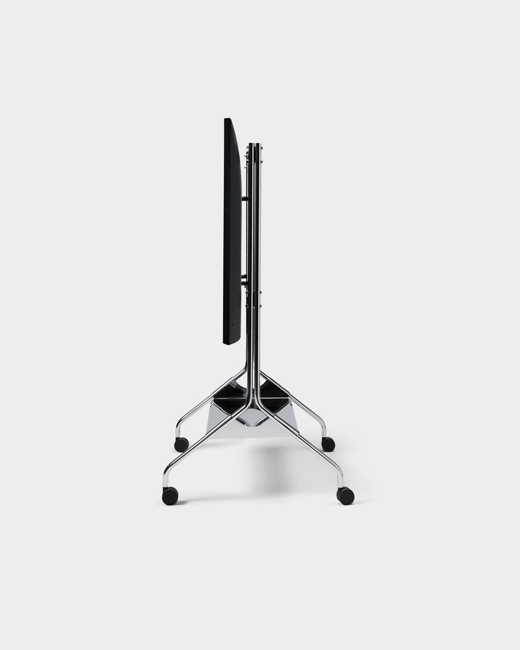 Moon Tray Shelf in Chrome folded flat in a studio packshot, side view showing black top, chrome legs and casters