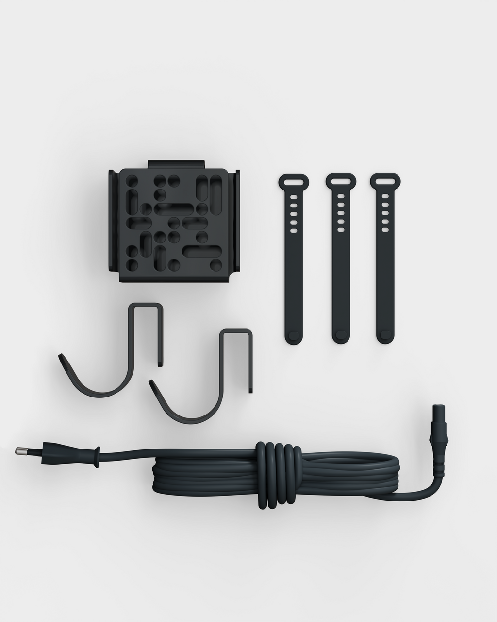 Mount Bundle in Charcoal laid flat on light gray studio backdrop with wall plate, two hooks, three straps and cable
