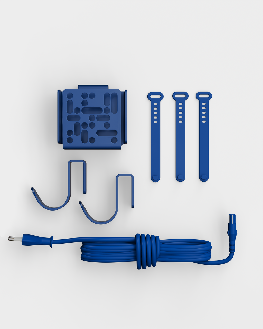 Mount Bundle in Ultra Marine laid flat on white studio backdrop: wall mount, three cable straps, two hooks and coiled cord
