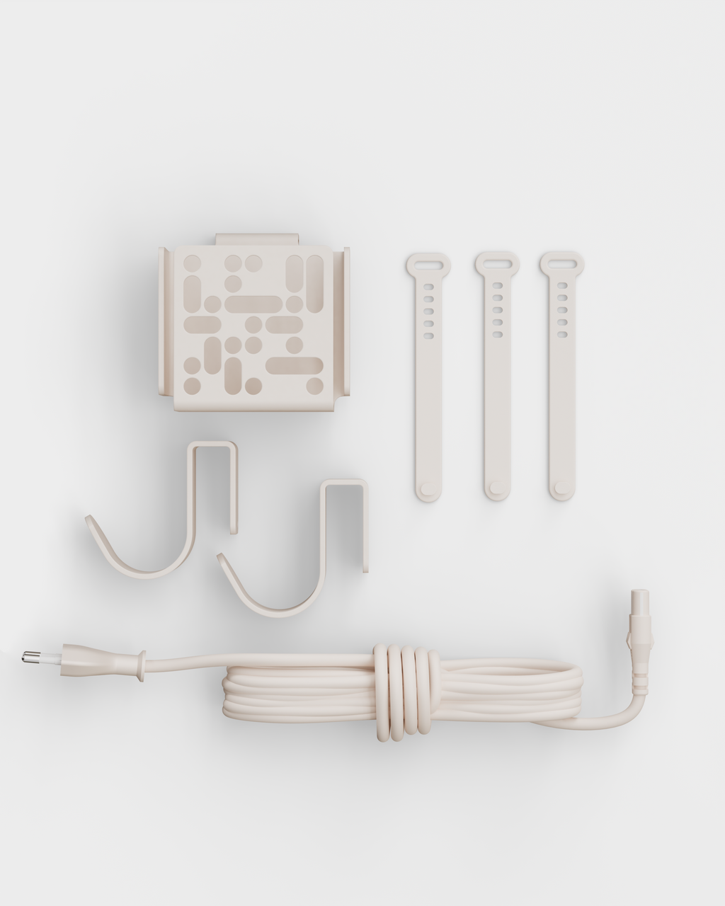 Mount Bundle in Pearl laid flat on white studio backdrop: wall mount plate, two hooks, three cable straps and coiled cord