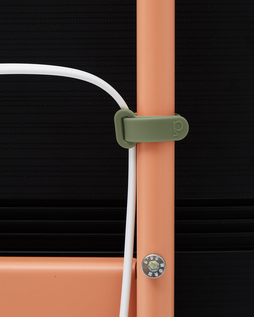 Mossy Green Mount Bundle strap wrapped around a coral stand leg, close-up detail holding a white cable in place