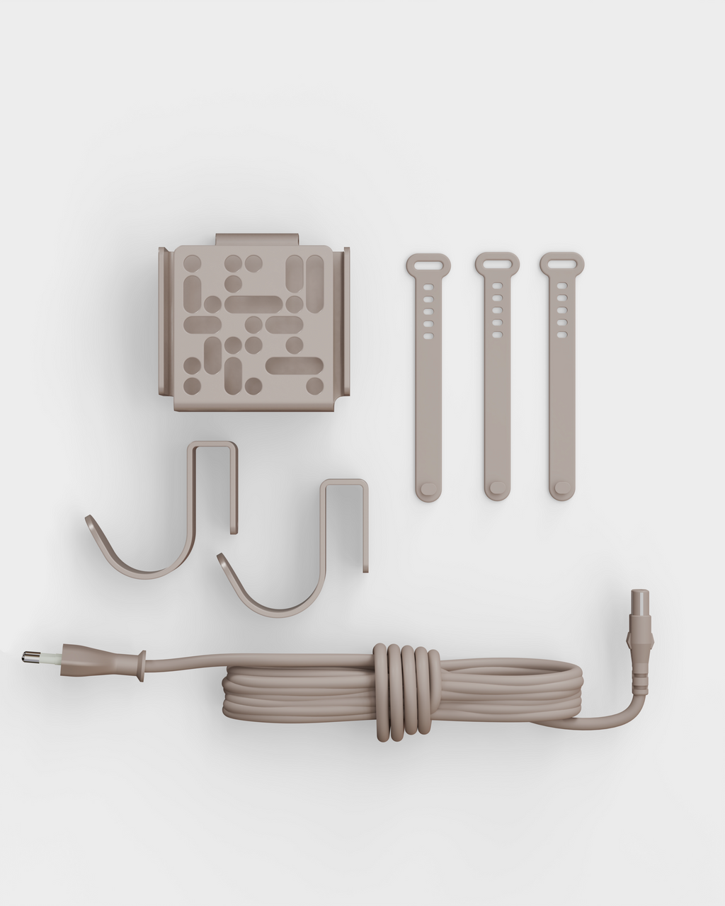 Mount Bundle in Oat laid flat on white studio backdrop: wall plate, two hooks, three cable straps and coiled power cord