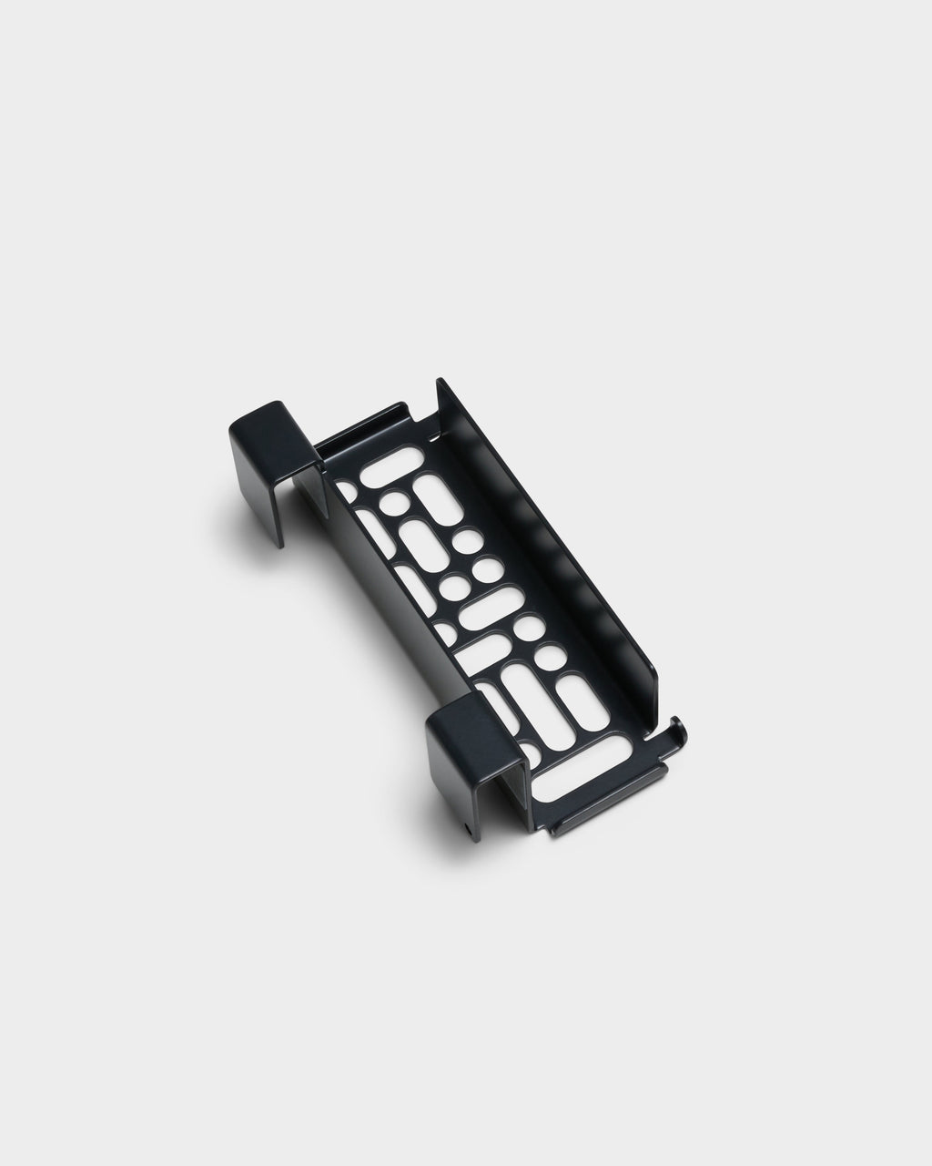 Charcoal Nintendo Switch 2 Mount shown at an angle in a studio packshot, showing perforated steel cradle and clips