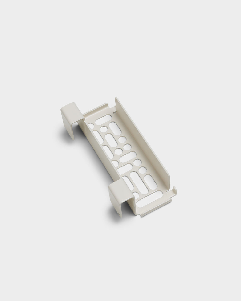 Pearl Nintendo Switch 2 Mount shown at an angle in a studio packshot, revealing perforated cradle and hooked side clips