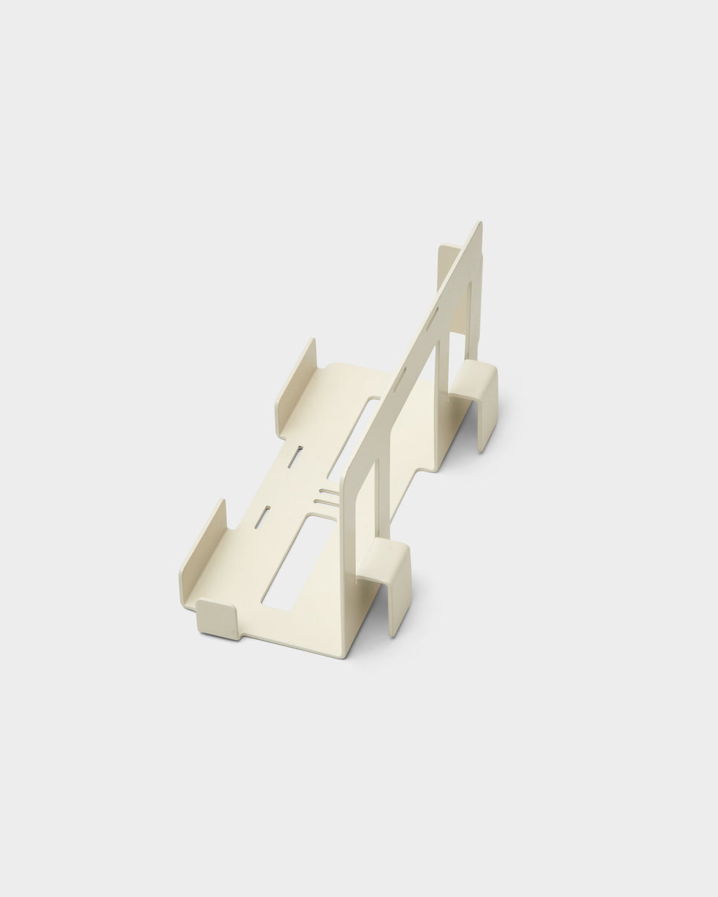 Pearl PS5 Mount studio packshot, angled overhead view showing folded steel cradle, slotted vents and upright back plate