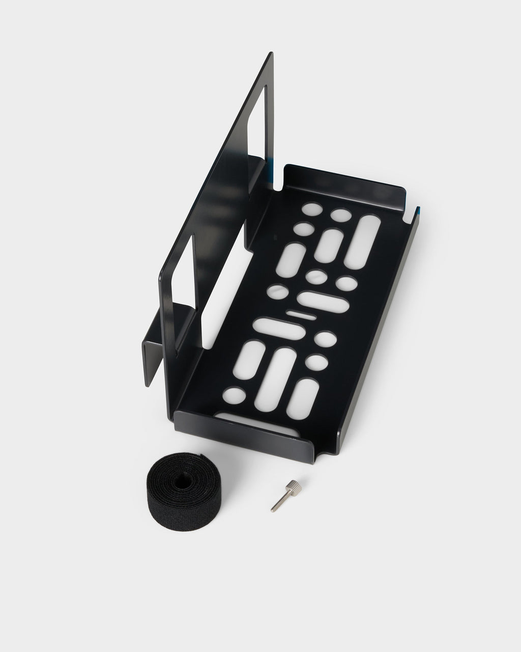 Charcoal PS5 Slim Mount studio packshot at an angle, shown with included velcro cable strap roll and thumbscrew