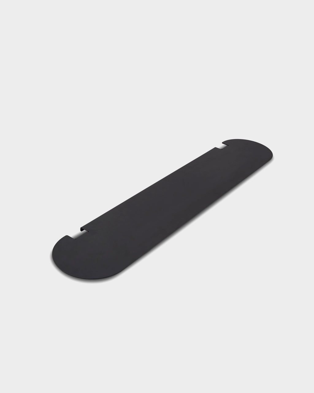 Moon Shelf in Charcoal shown at an angle as a studio packshot, highlighting its rounded ends and notched edges