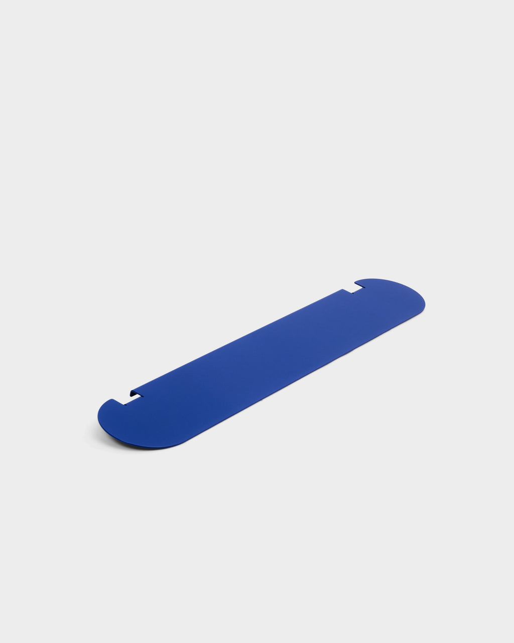 Moon Shelf in Ultra Marine shown at an angle in a studio packshot, highlighting its rounded ends and notched edges