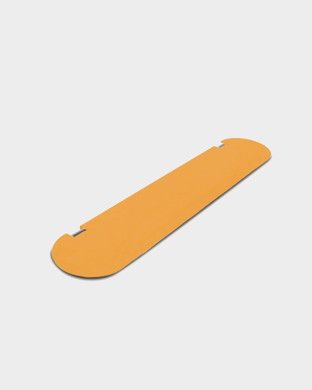 Moon Shelf in Apricot shown at an angle in a studio packshot, revealing its rounded ends and notched back edge