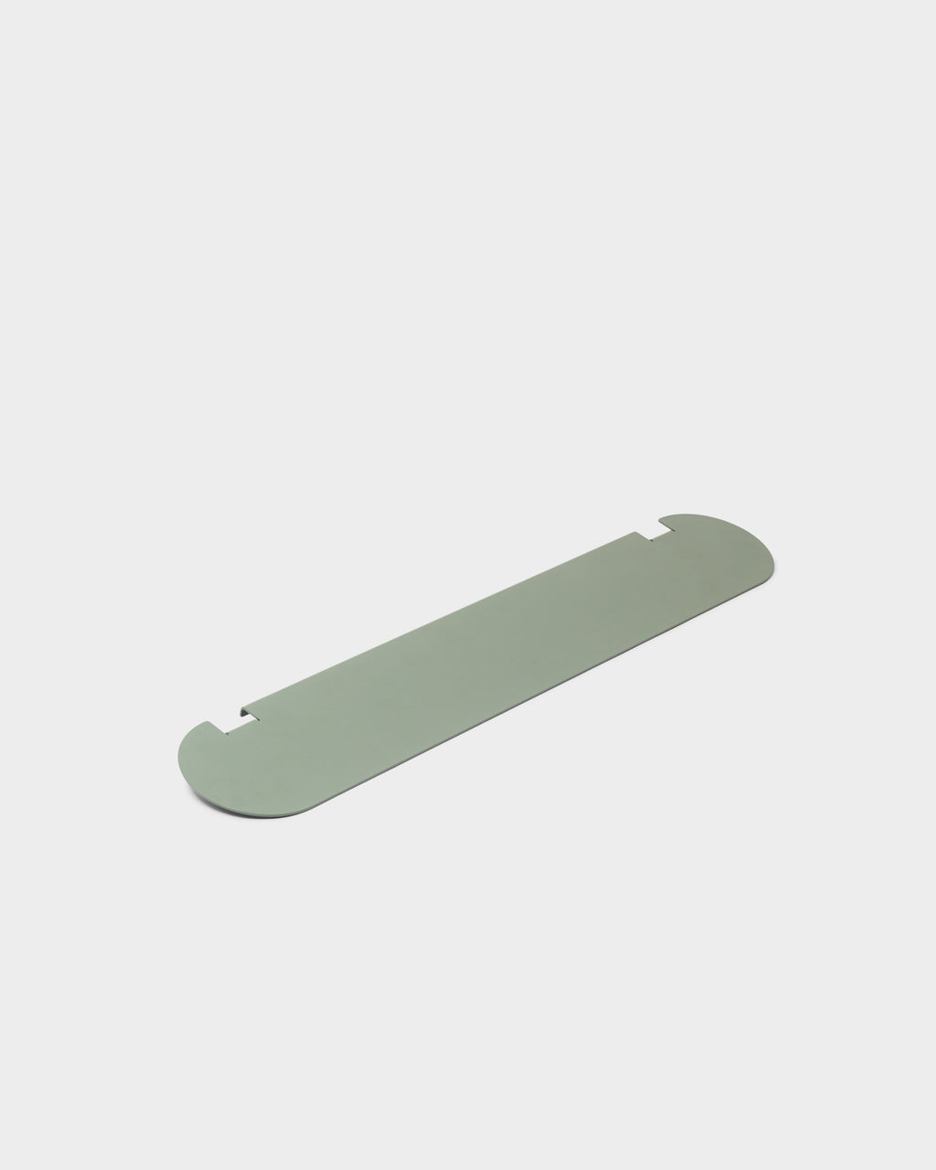 Moon Shelf in Mossy Green shown at an angle as a studio packshot, highlighting its rounded ends and notched edges