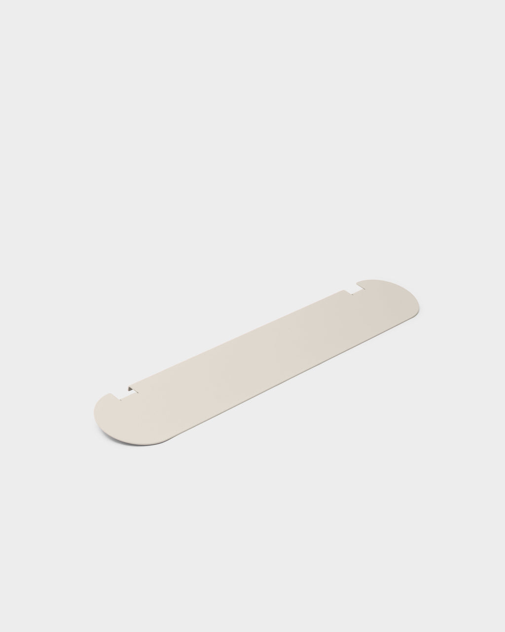 Moon Shelf in Oat shown at an angle as a studio packshot, flat rounded metal shelf panel with notched edges