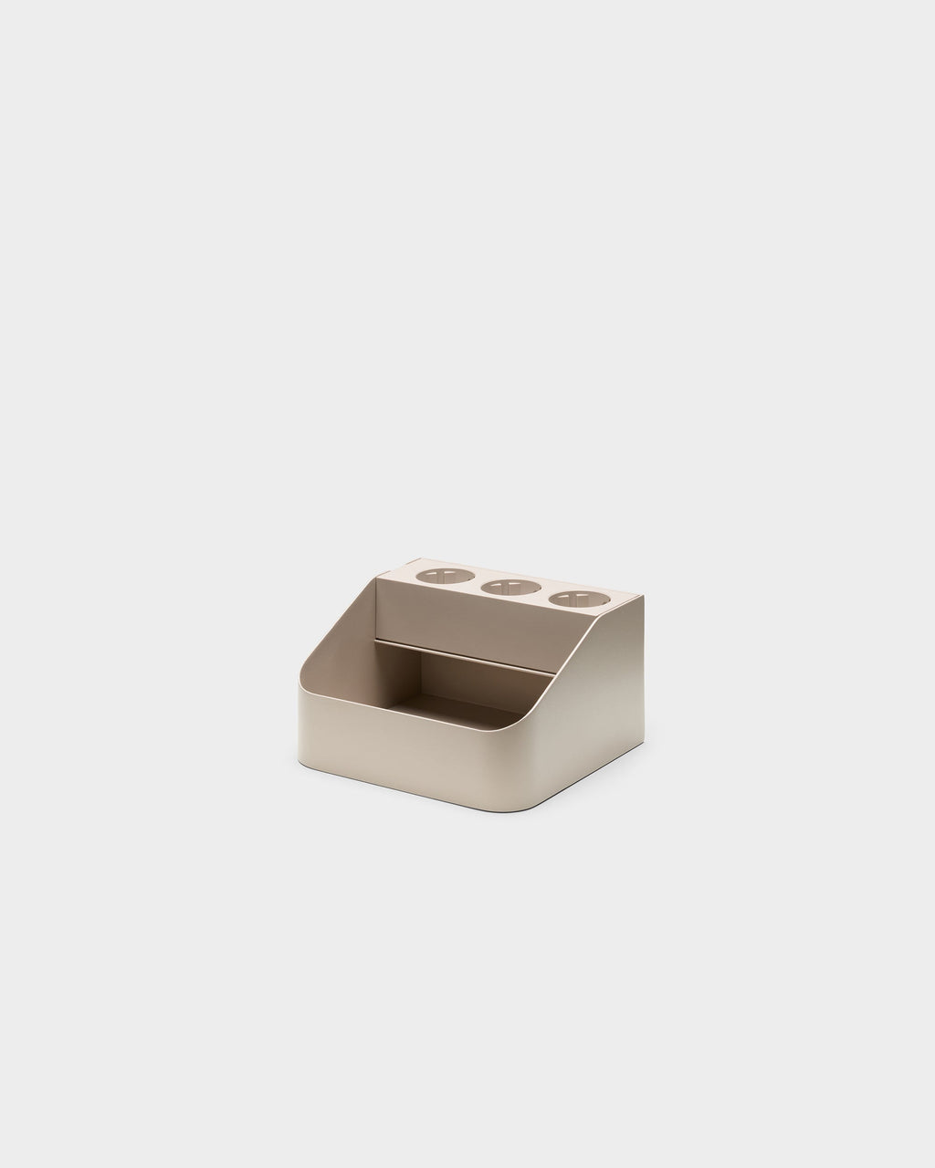 Angled studio view of the Oat Power Bar Tray, showing three round cable ports on top and open front storage shelf