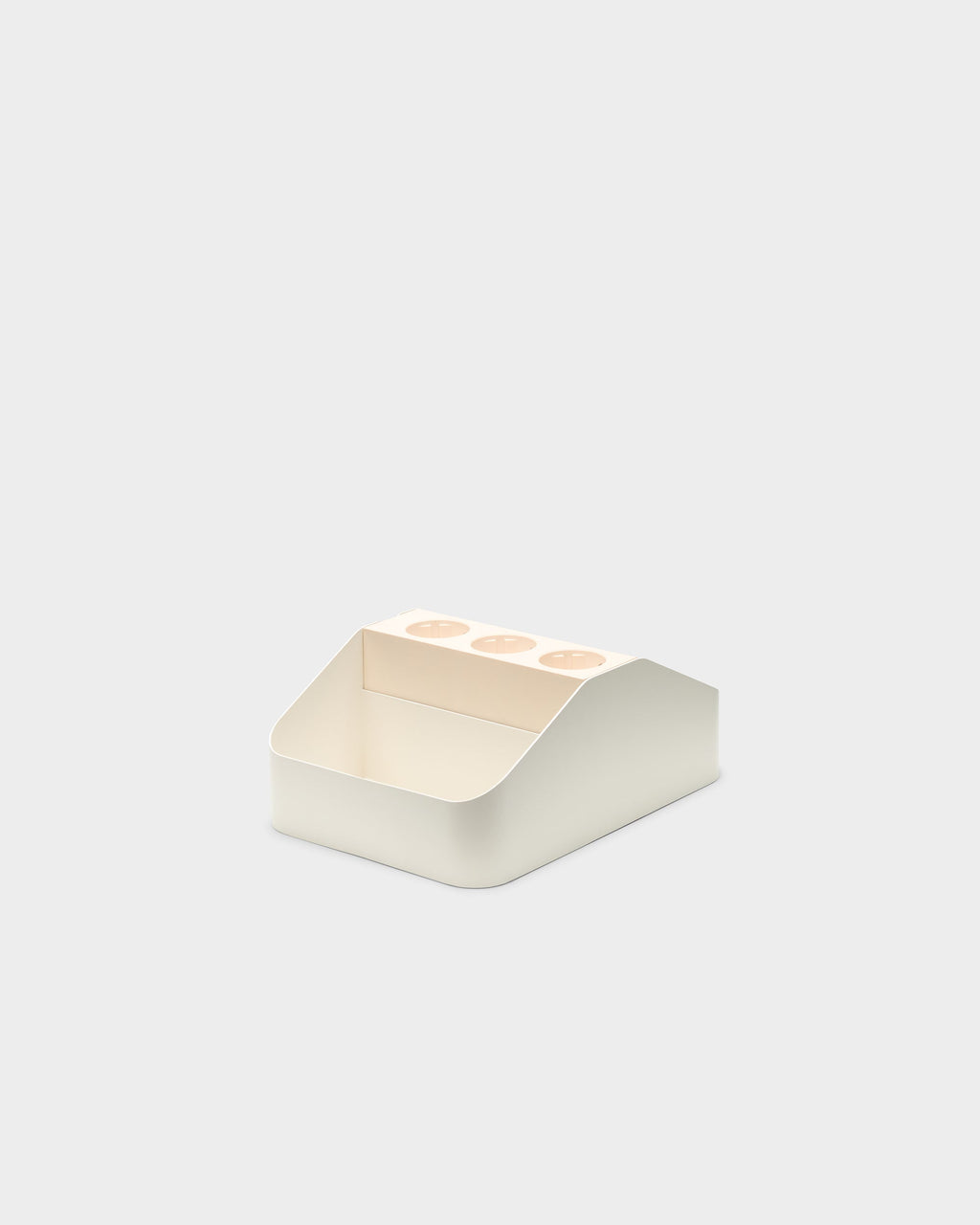 Angled studio view of the Pearl Power Bar Tray Double, showing three outlet cutouts and open front storage compartment