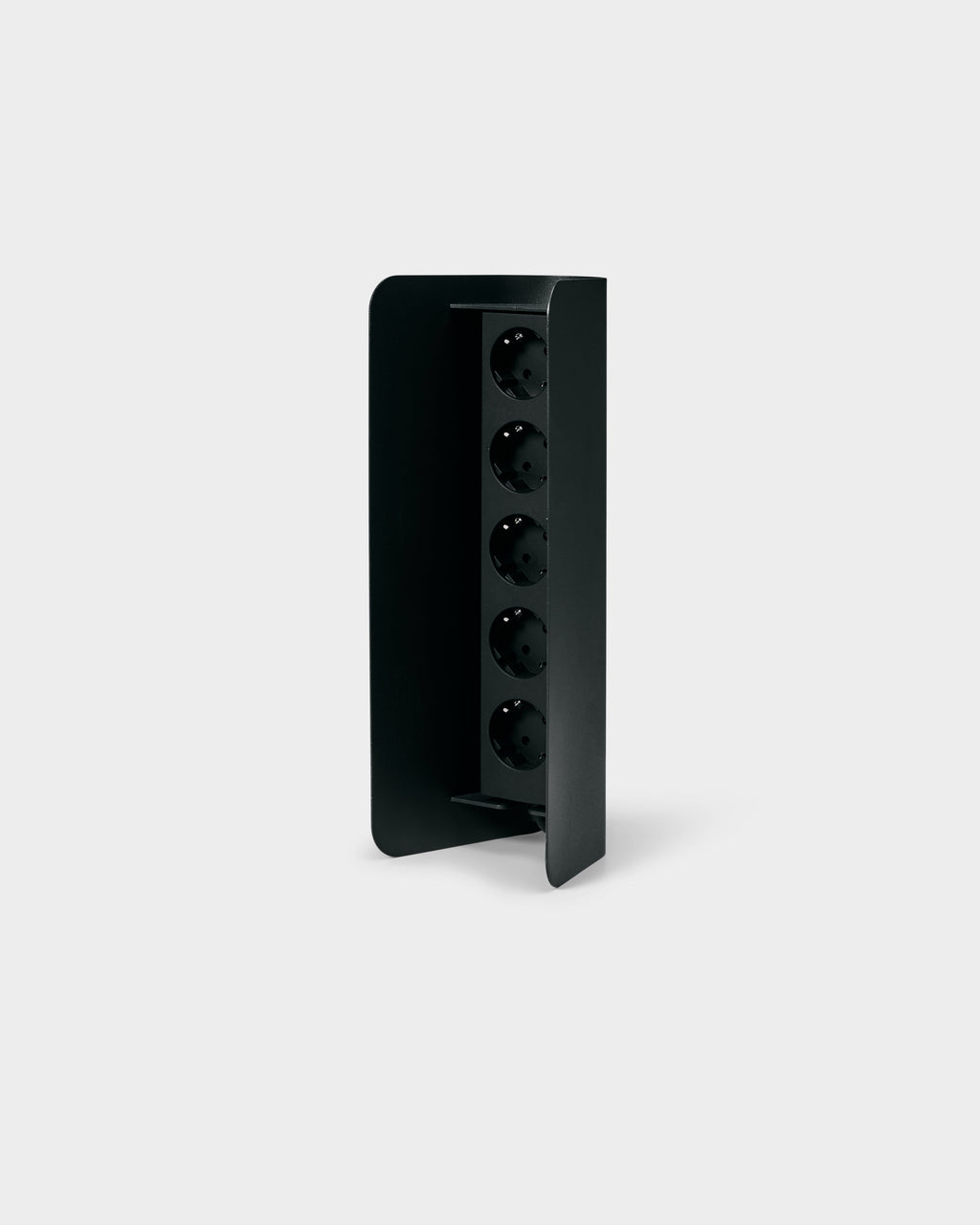 Angled studio packshot of the charcoal Power Shell, its curved metal cover revealing five recessed vertical sockets
