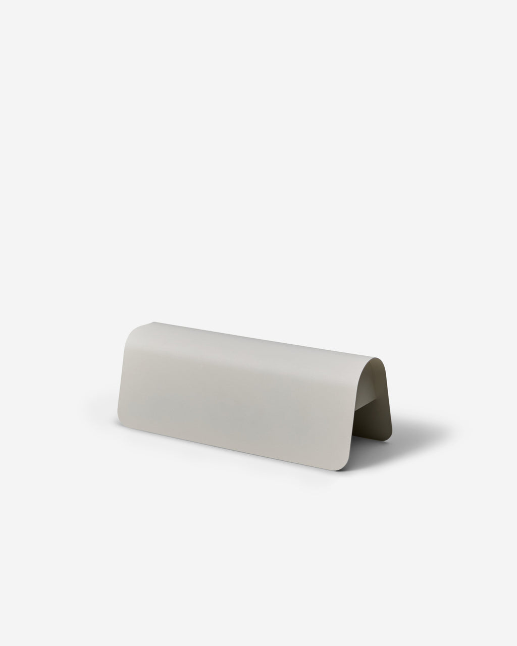 Power Shell in Pearl studio packshot at an angle, curved metal cable cover shown from the front with open underside