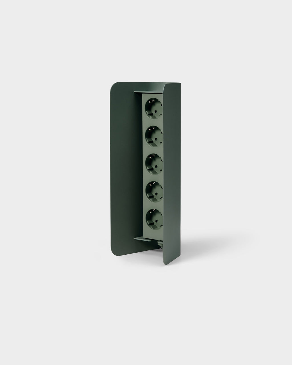 Angled studio view of Power Shell in Mossy Green, curved metal cover revealing a five-socket power strip inside