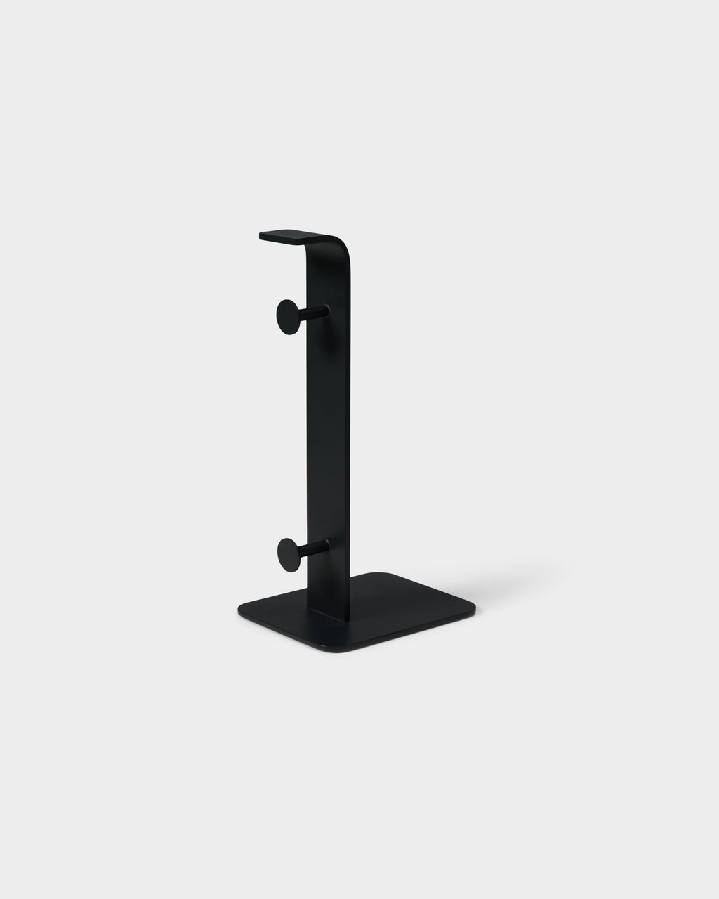 Charcoal Power Tower studio packshot at three-quarter angle, showing slim vertical post, two peg hooks and square base