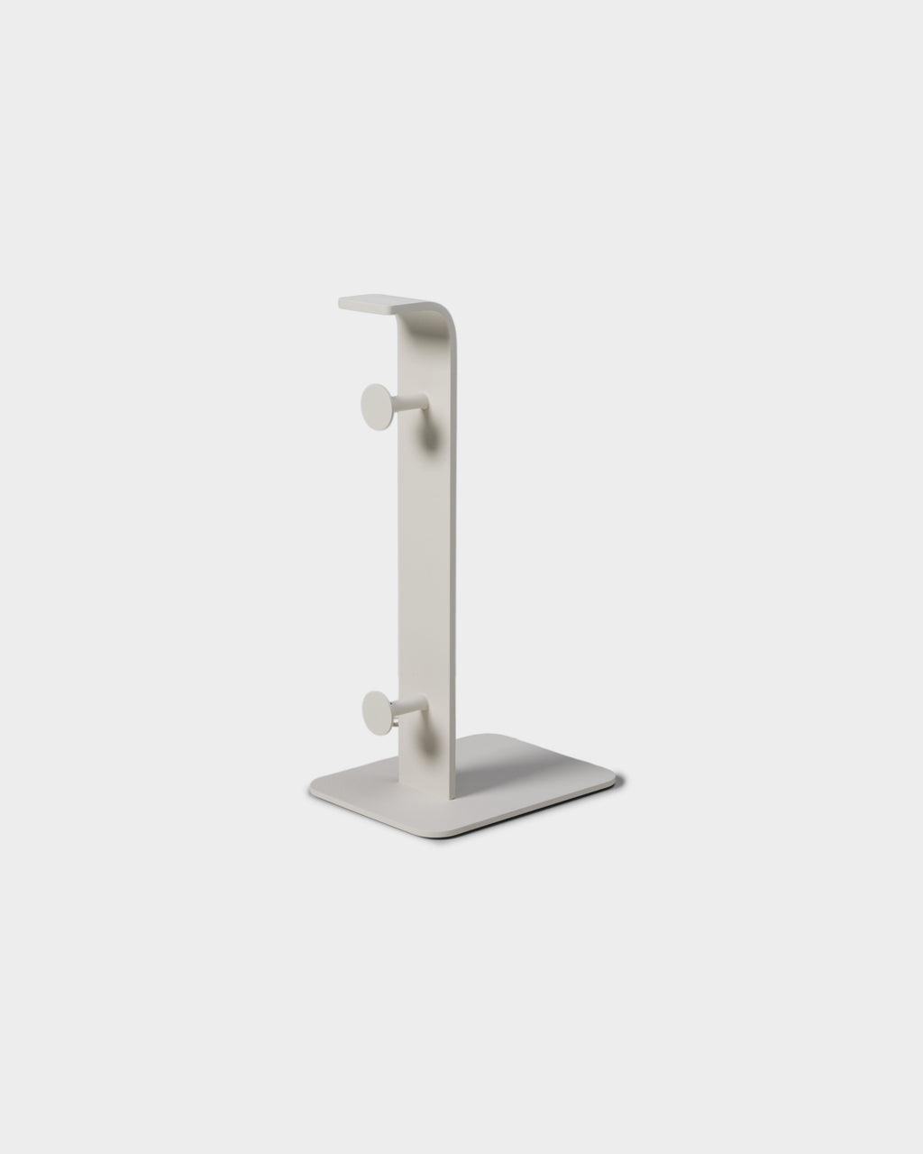 Power Tower in Pearl shown at an angle in a studio packshot, upright post with two round pegs on a flat square base