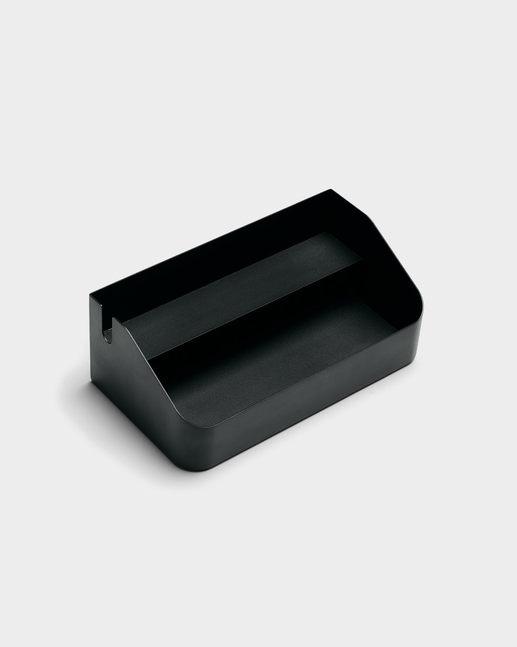 Charcoal Power Beam Tray shown at a three-quarter angle in a studio packshot, revealing its divided interior and cable notch