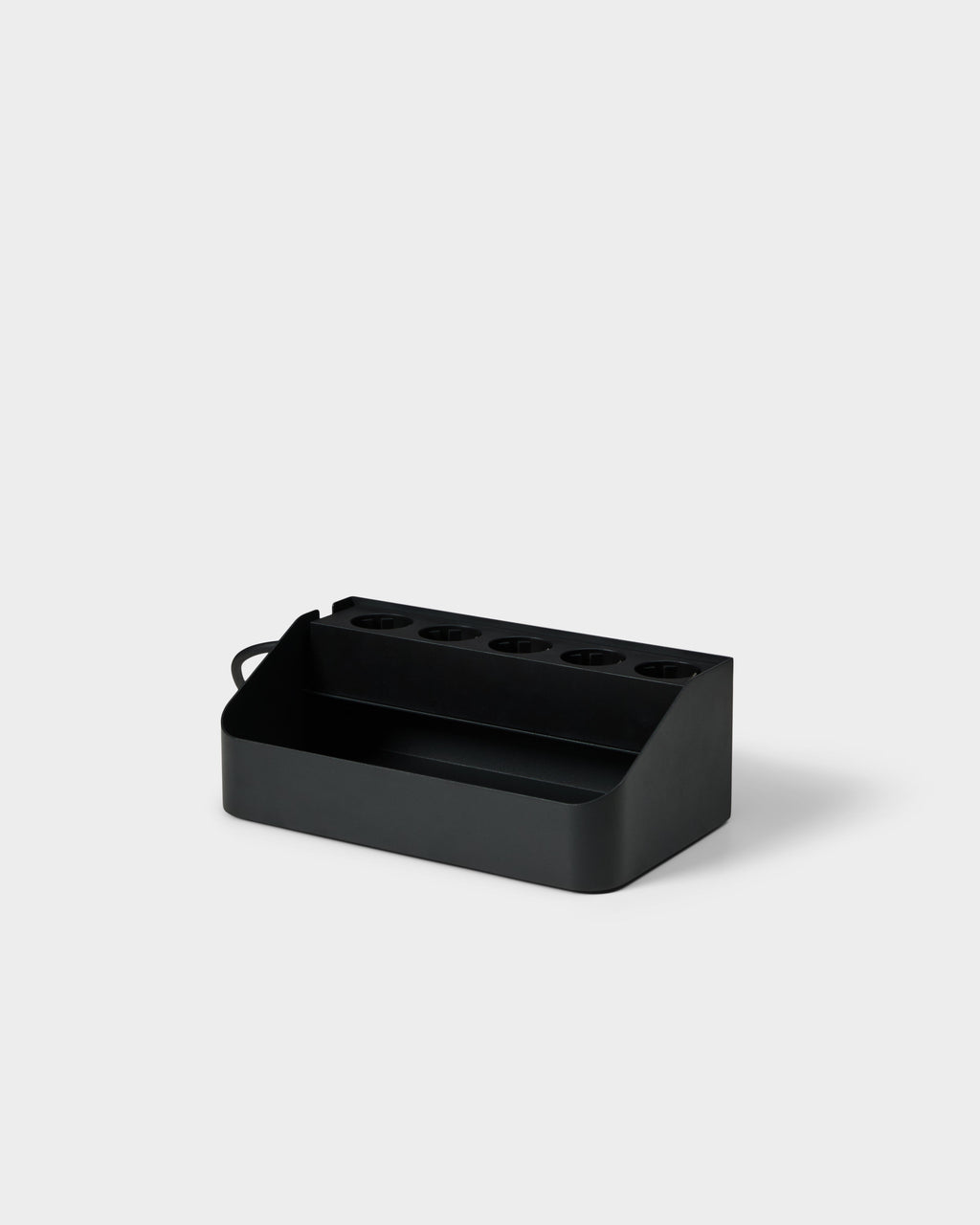 Angled studio view of the charcoal Power Beam Tray, showing five recessed outlet ports and open front storage compartment