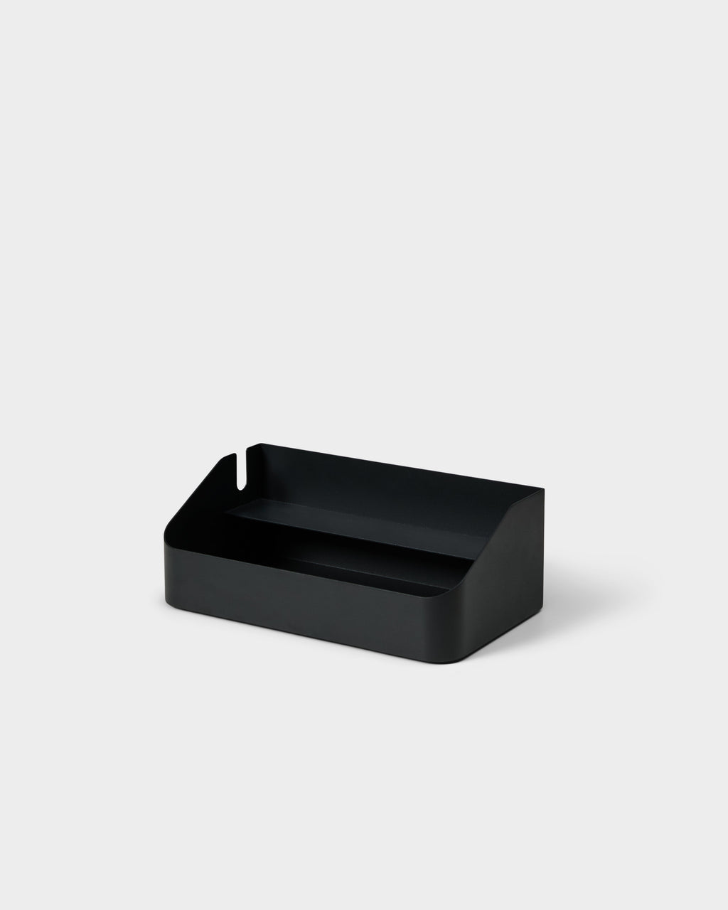 Charcoal Power Beam Tray shown at an angle in a studio packshot, with cable notch and raised inner divider shelf