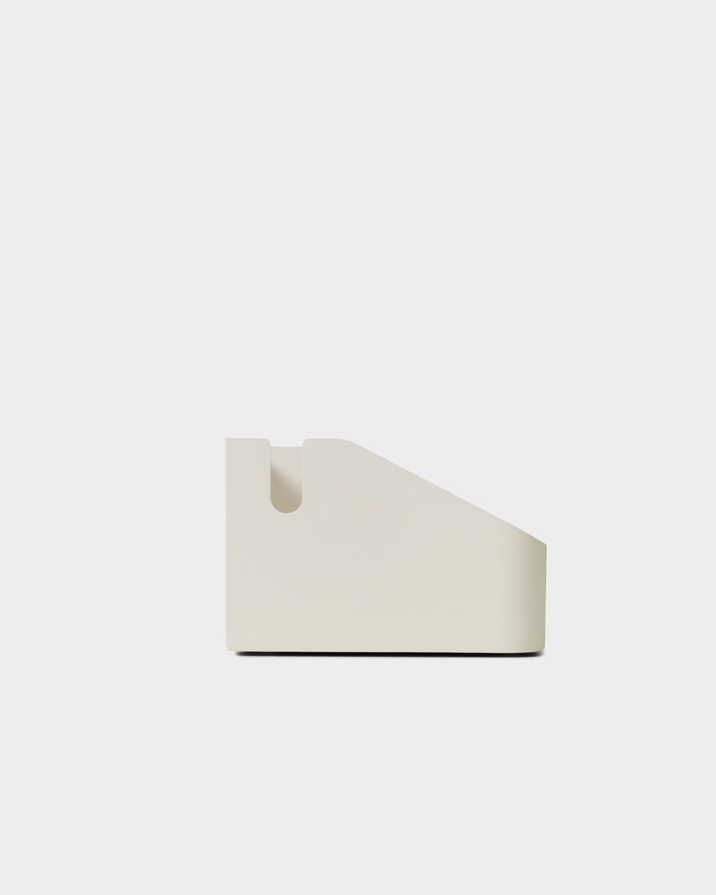 Side profile studio packshot of the Power Beam Tray in Pearl, showing its wedge shape and rounded cable slot