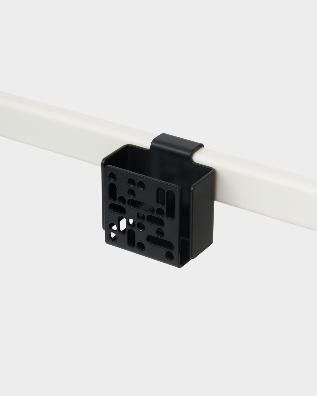 Charcoal Remote Box Mount clipped onto a white rail in a studio packshot, angled to show its perforated front panel