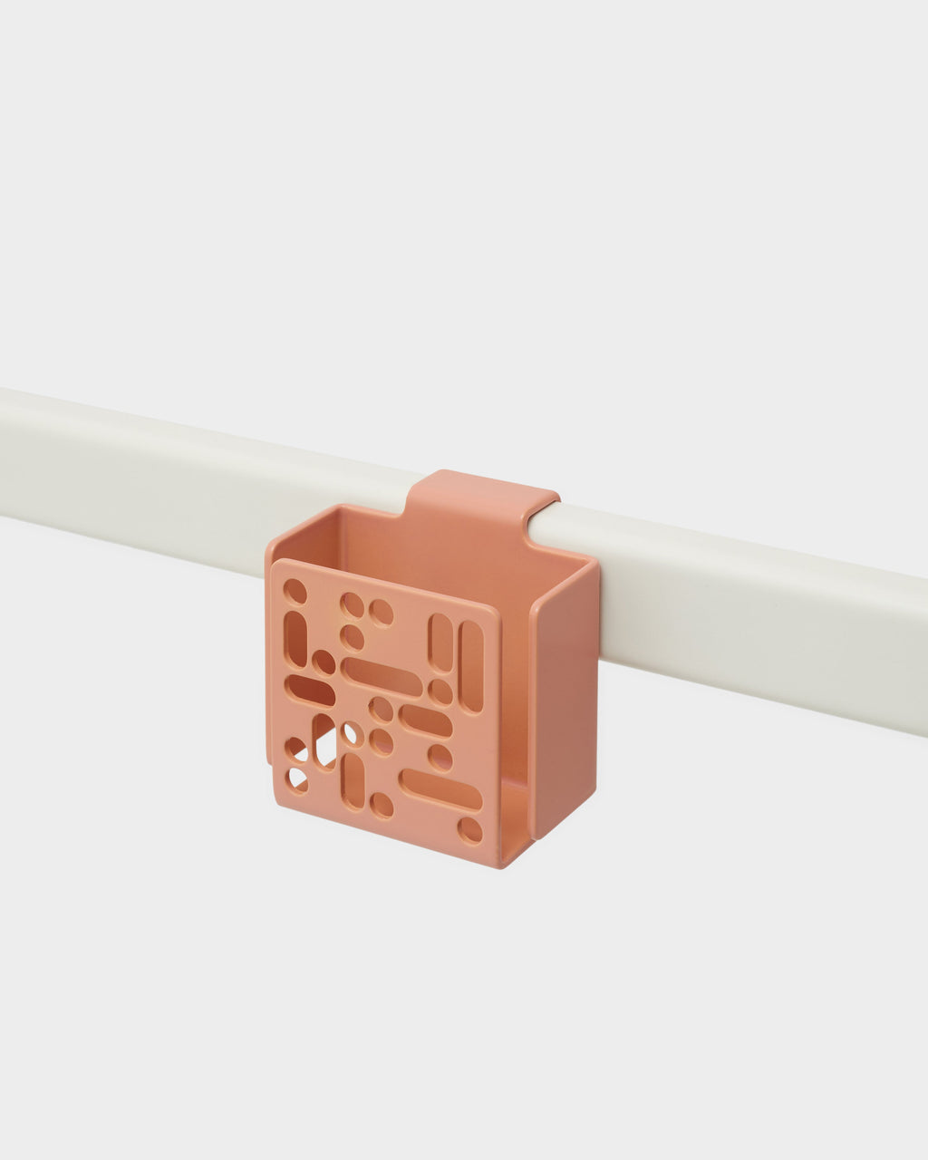 Dusty Rose Remote Box Mount clipped onto a cream rail, angled studio packshot showing its perforated front panel