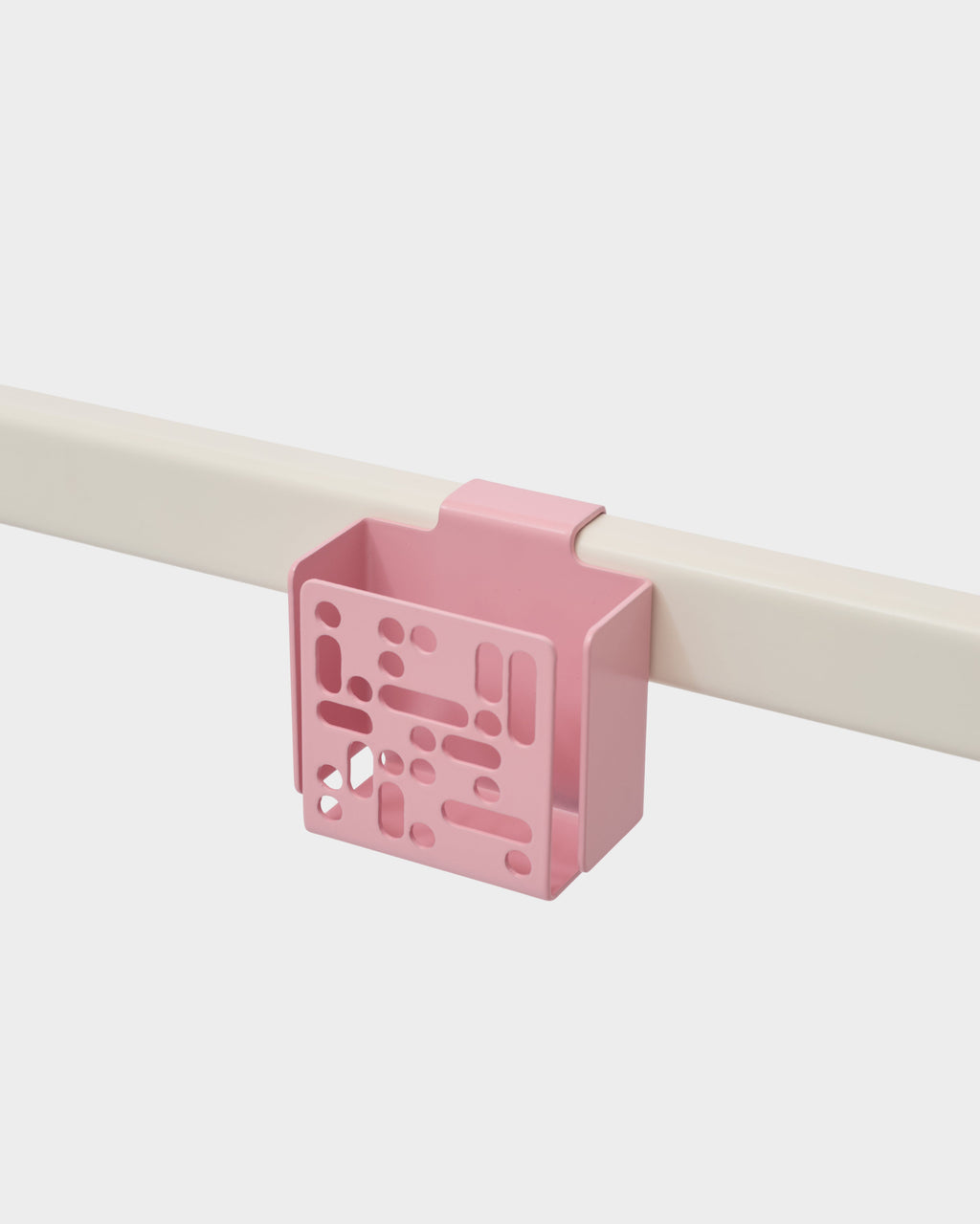 Bubble Gum pink Remote Box Mount clipped onto a cream rail, studio packshot showing perforated front panel