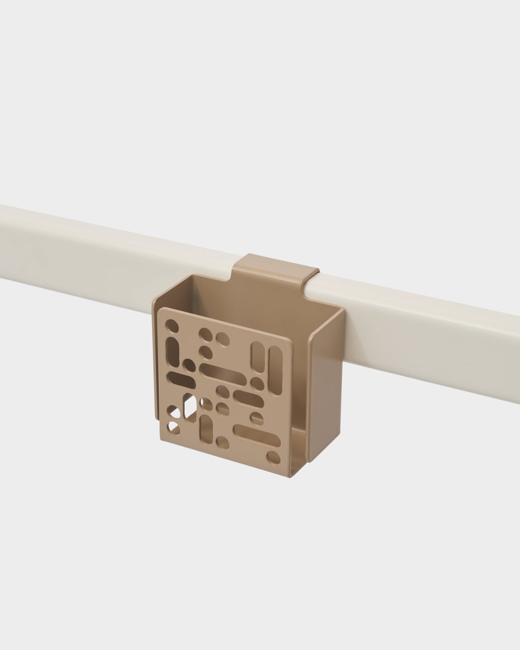 Sandstorm Remote Box Mount clipped onto a cream bed rail, studio packshot angled to show perforated front panel