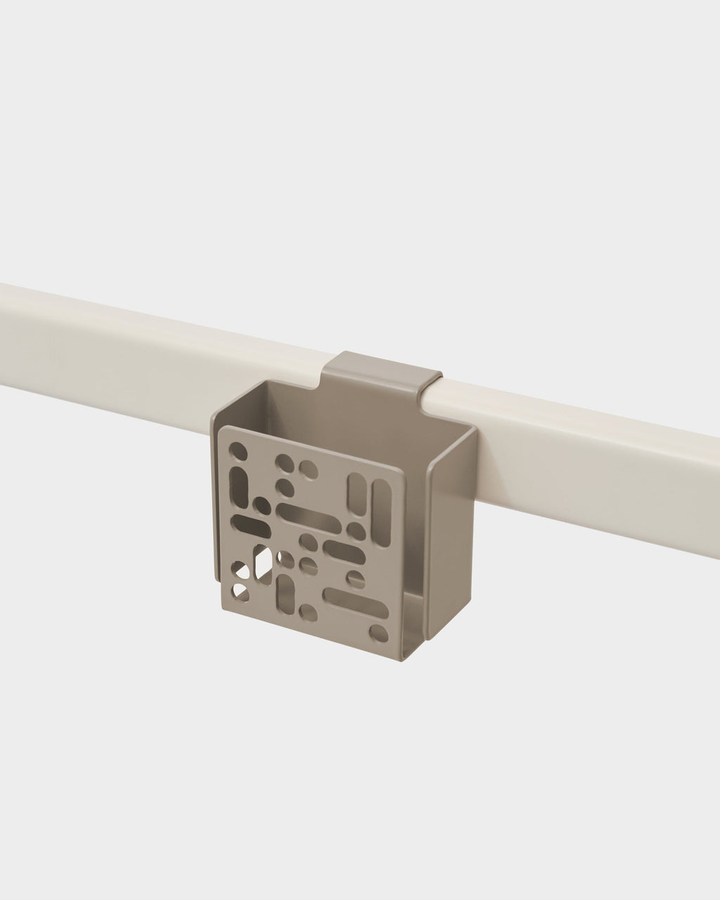 Oat Remote Box Mount clipped onto a cream rail, studio packshot showing perforated front panel at an angle