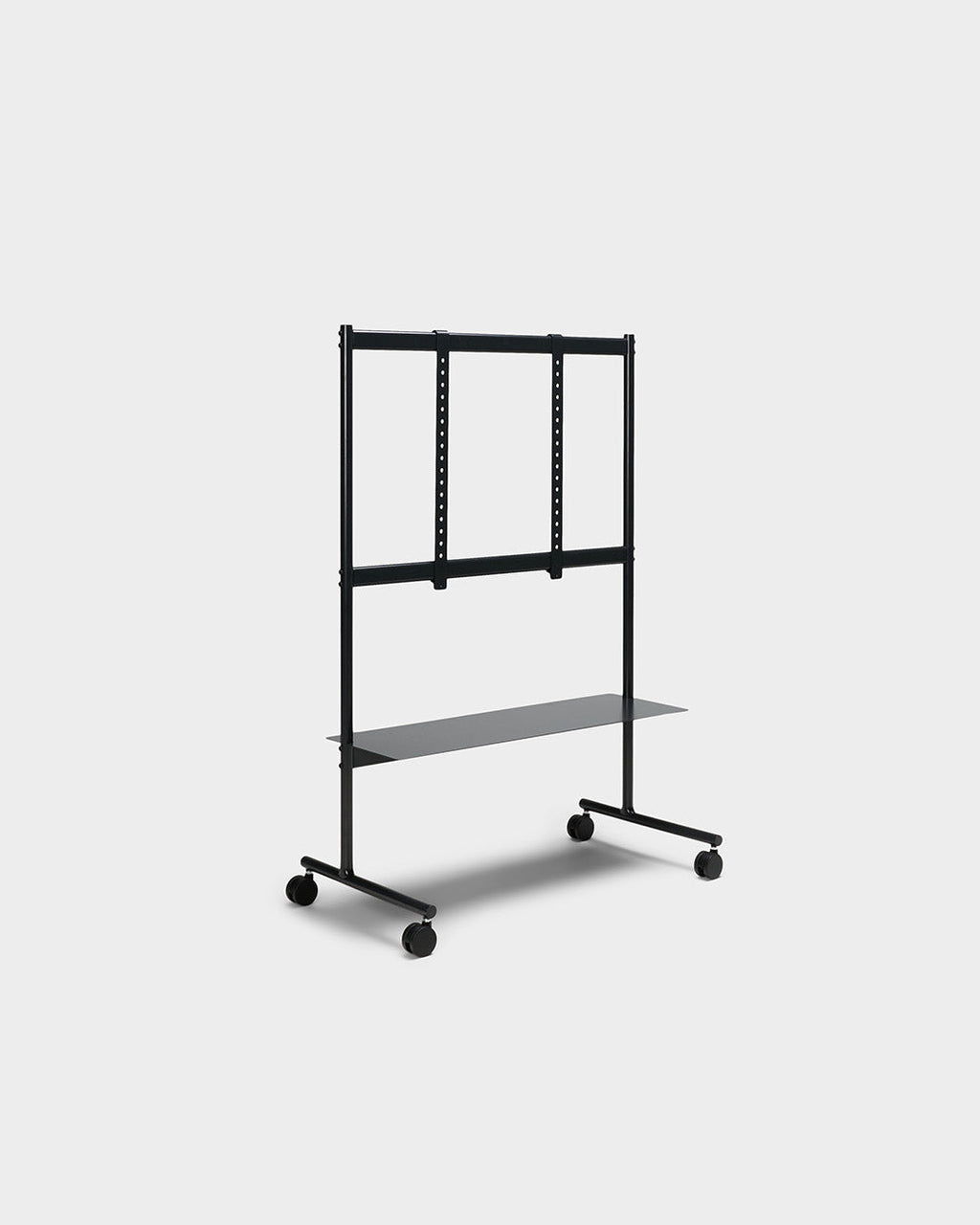 Rover TV stand in Charcoal shown at an angle in studio, featuring VESA mount rails, lower shelf and locking wheels