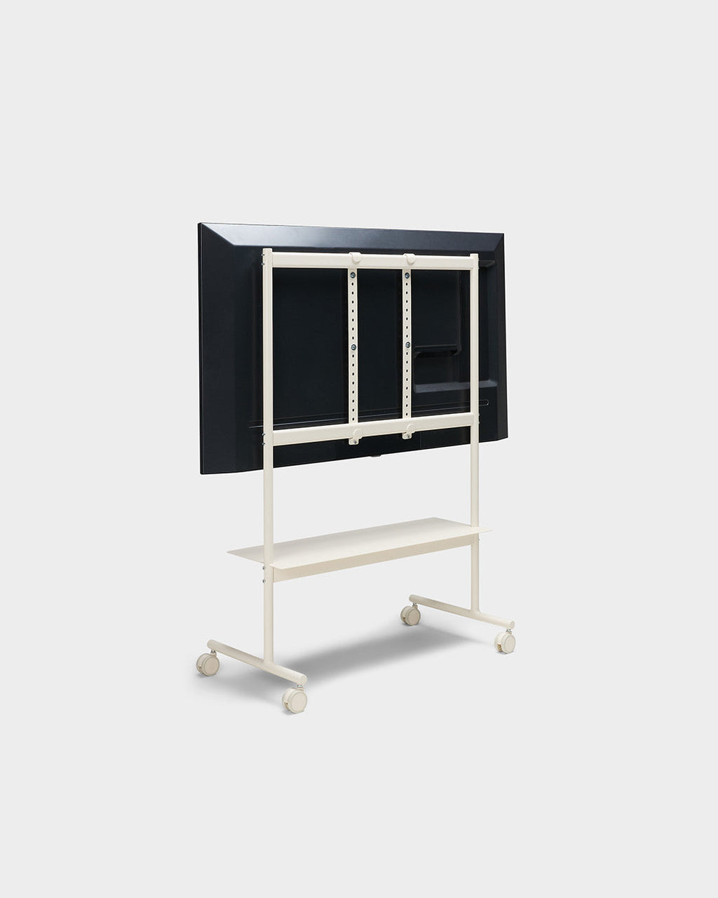 Rear angled view of the Rover TV stand in Pearl with mounted display, shelf and locking wheels on a studio backdrop