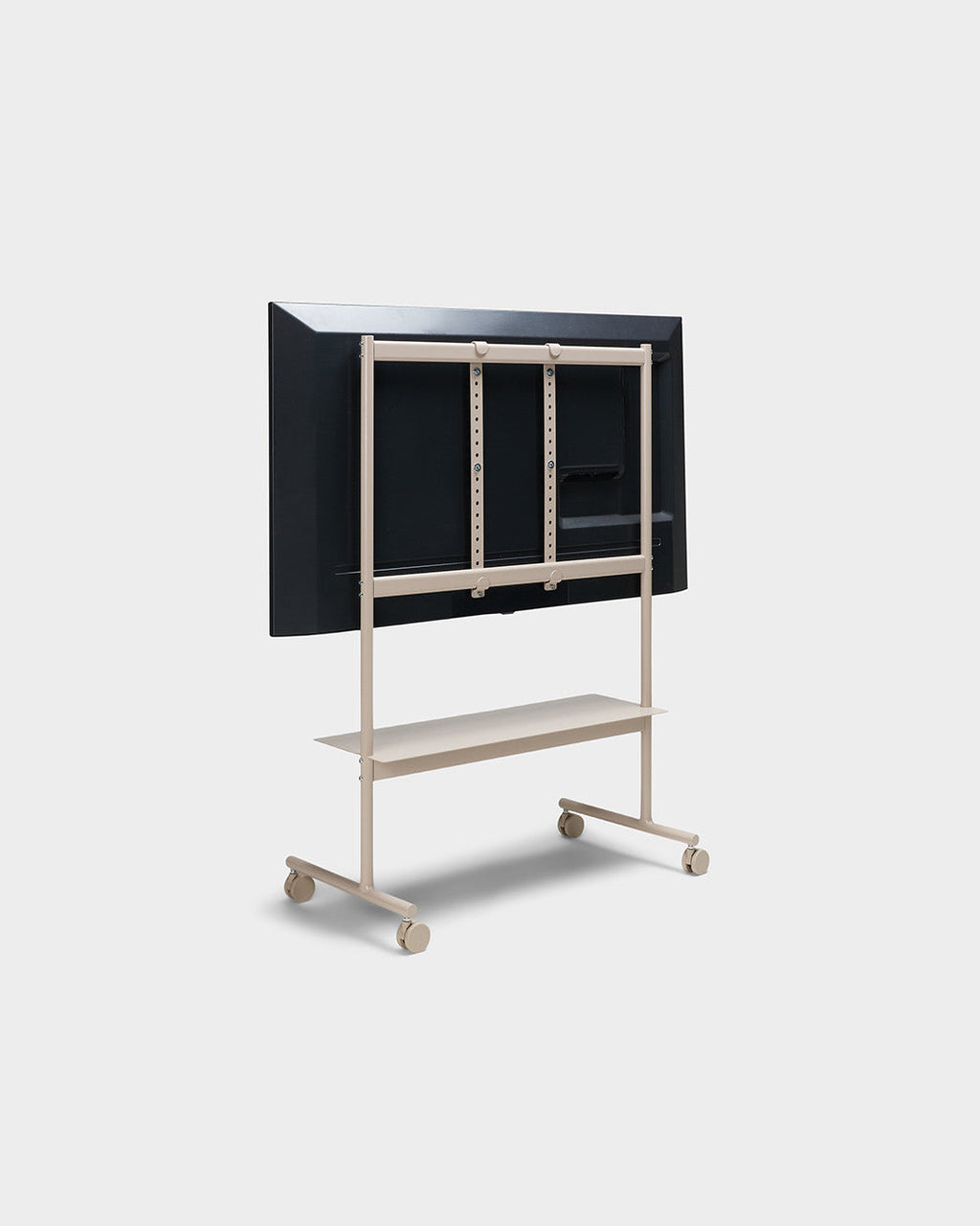 Rear view of Rover mobile TV stand in Oat with mounted display, storage shelf and locking wheels on studio white