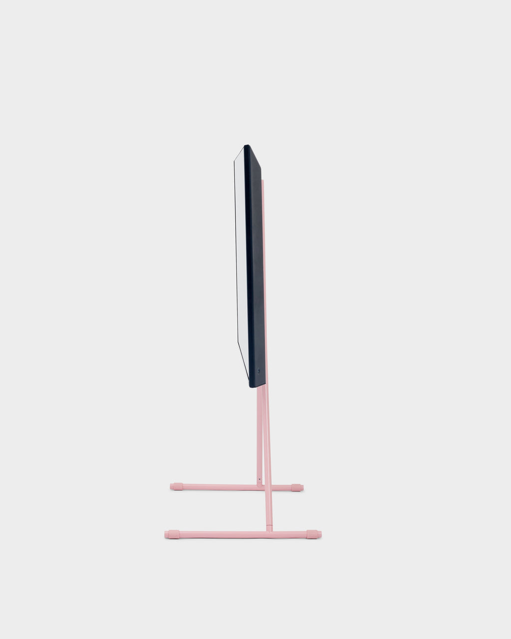 Side profile studio shot of the Viva TV stand in Bubble Gum pink with slim TV mounted on twin-pole tubular legs