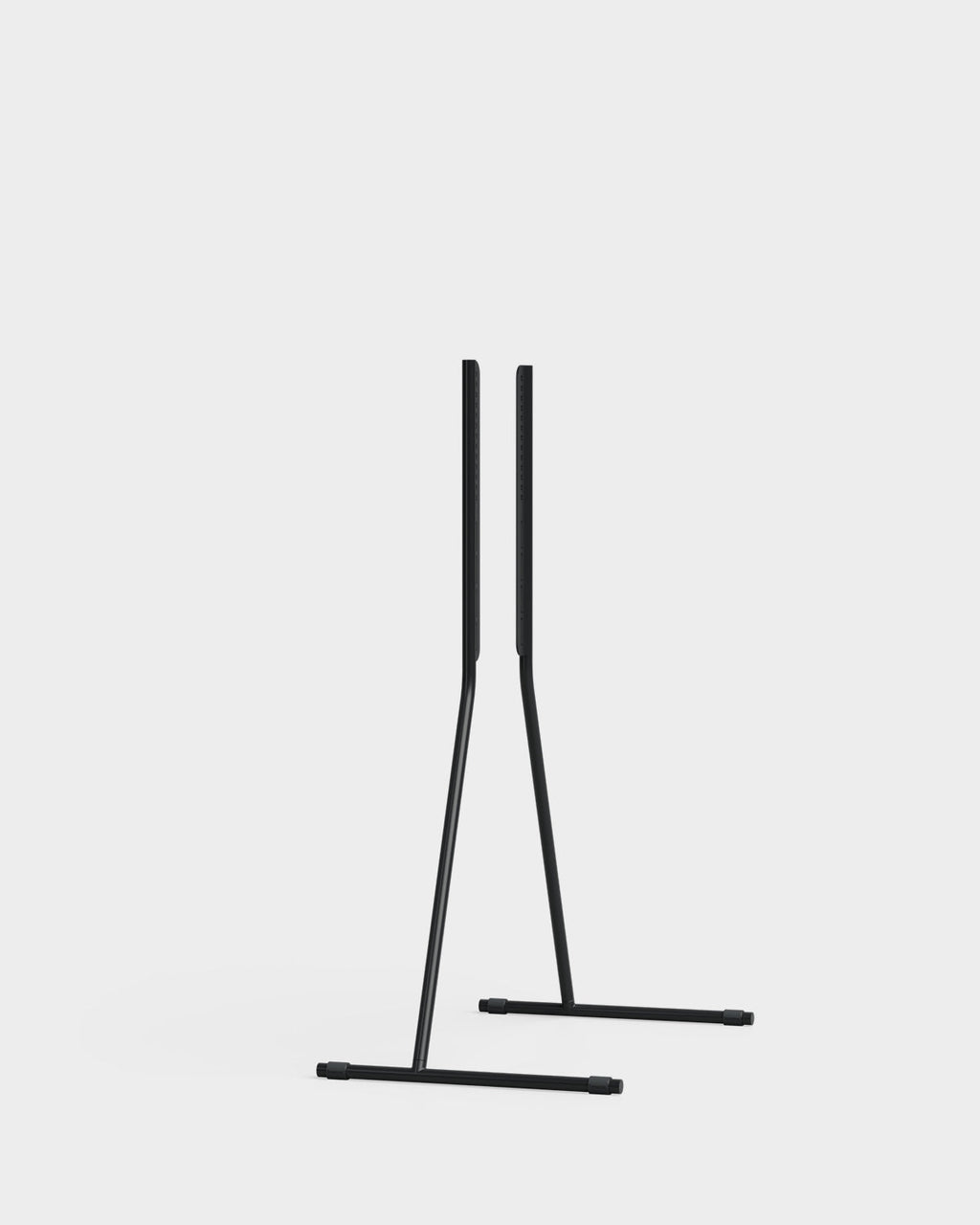 Viva TV stand in Charcoal holding a large flat-screen TV, angled studio packshot showing splayed tripod legs